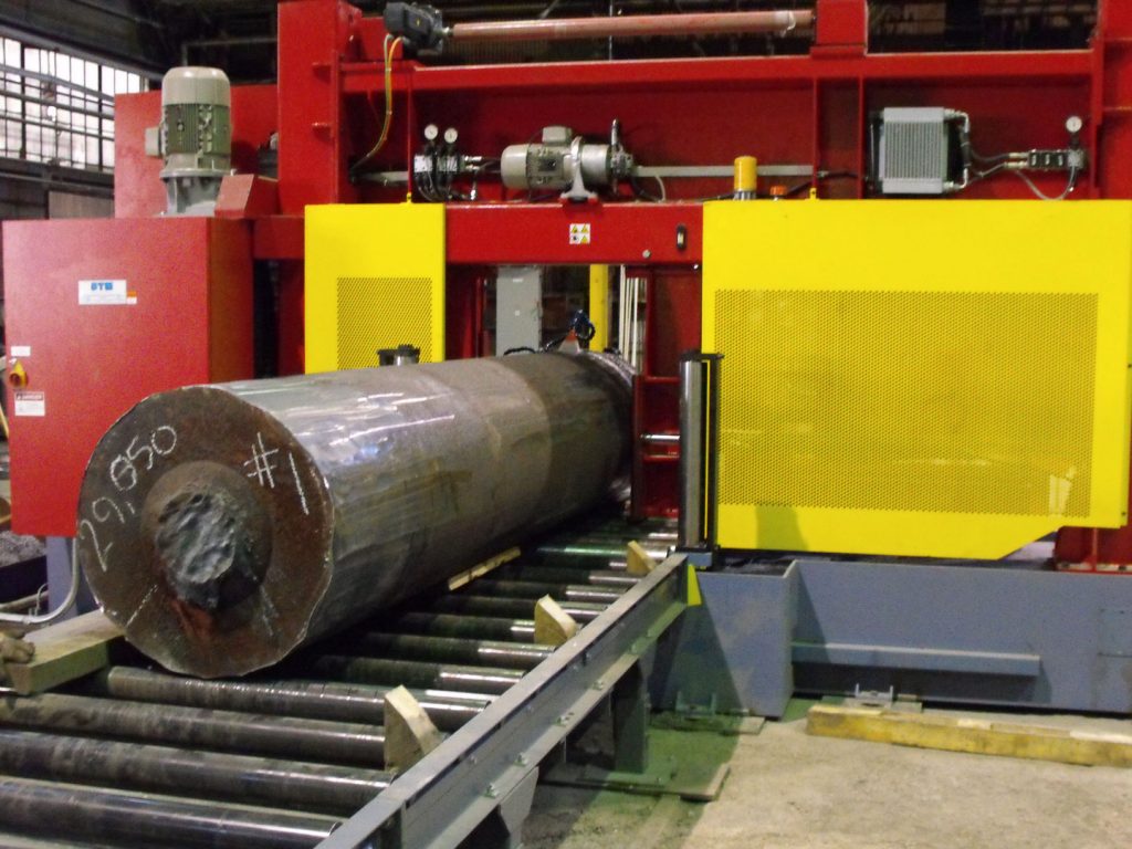 Large cylinder of metal on a conveyor belt